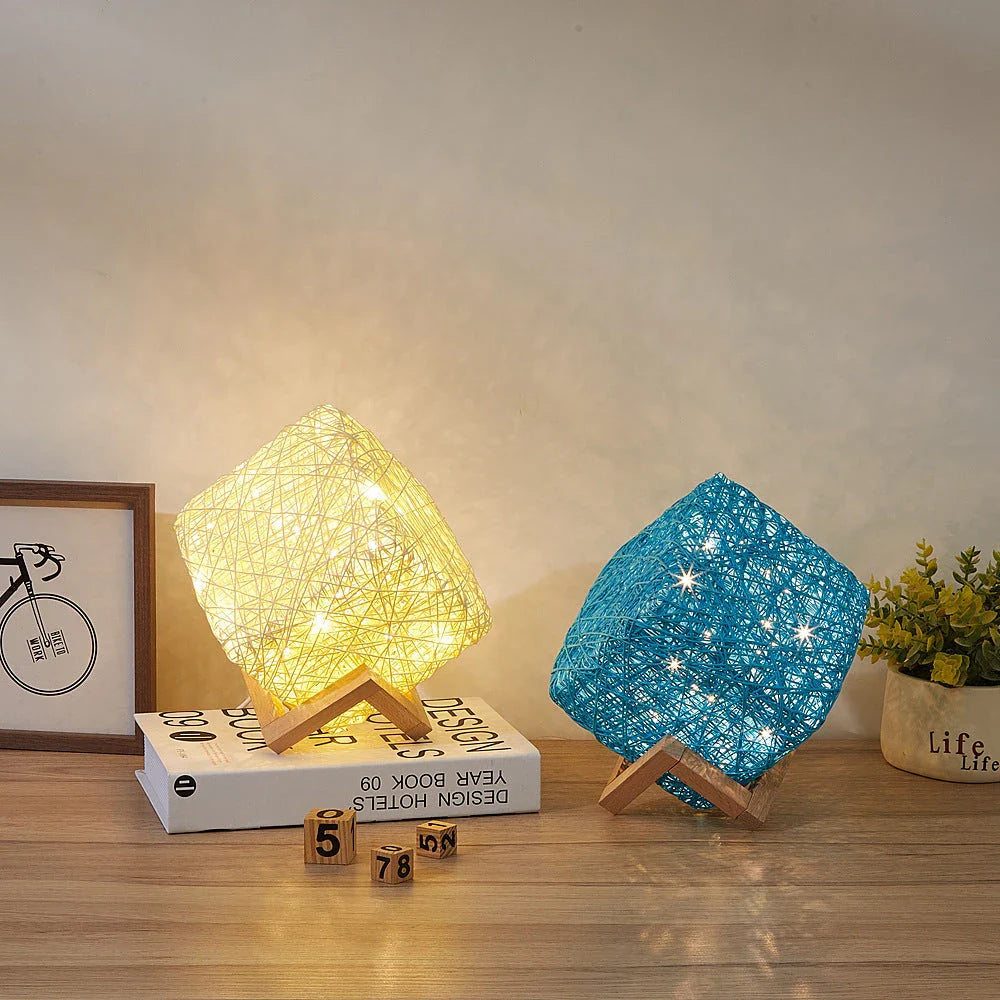 Handcrafted dimmable LED desk lamp made from sustainable rattan and wood, providing adjustable lighting and USB charging for home or office use.