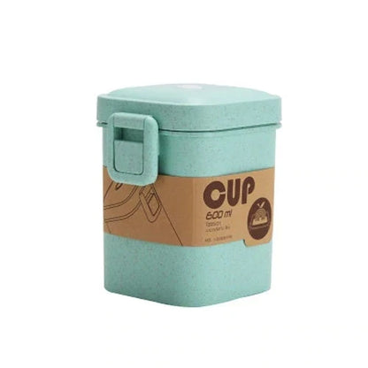 A stylish microwave-safe lunch box with a removable soup mug in various colours, including pink, green, and apricot