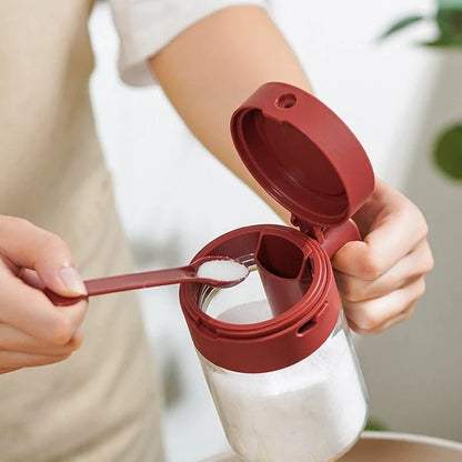 Small glass seasoning jars with lids and built-in spoons for easy measuring and storage