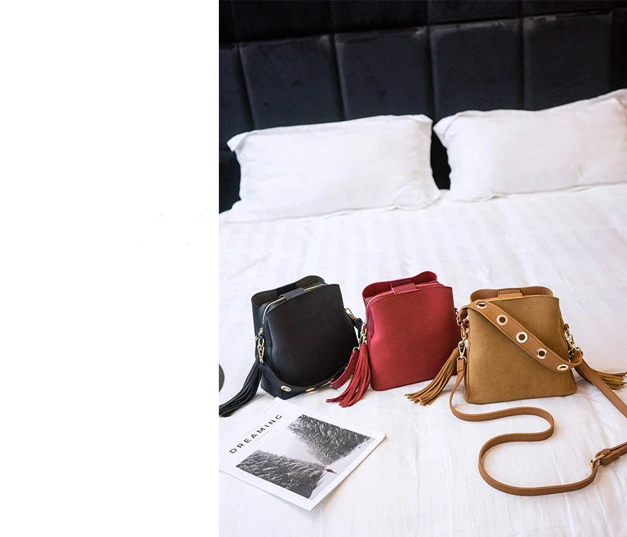 Trendy frosted tassel bucket bag in a range of classic colors, featuring a spacious interior and a dedicated camera pocket for maximum convenience.