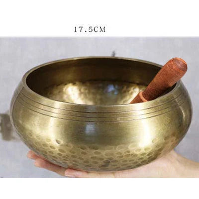 A handcrafted Tibetan singing bowl made of copper, used for meditation and relaxation.