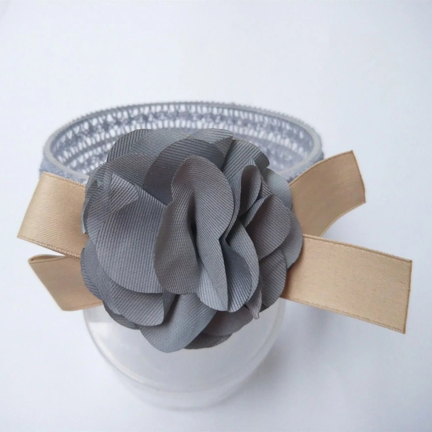 A beautiful floral headband for babies, featuring delicate flowers and a comfortable, adjustable design.