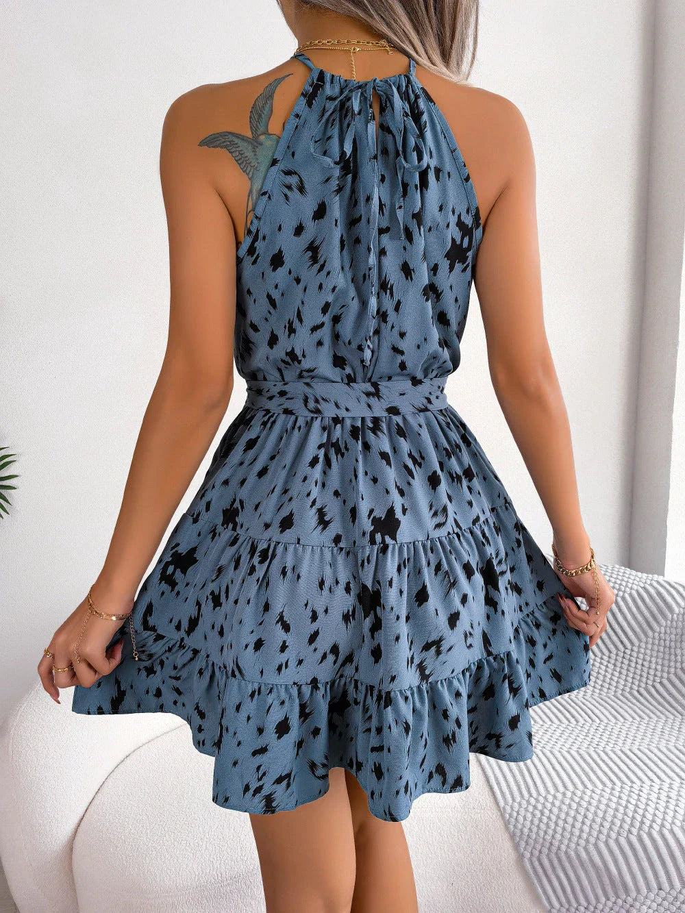 A fashionable leopard print swing dress with ruffled details and an A-line silhouette, perfect for summer style