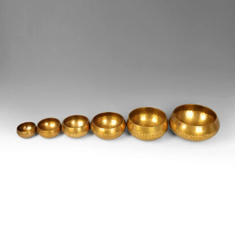 A handcrafted Tibetan singing bowl made of copper, used for meditation and relaxation.