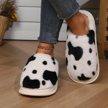 Cozy cow print plush slippers with a non-slip sole, perfect for indoor comfort and warmth
