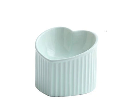 Elevated ceramic pet bowl with angled design for comfortable, natural feeding of cats and dogs