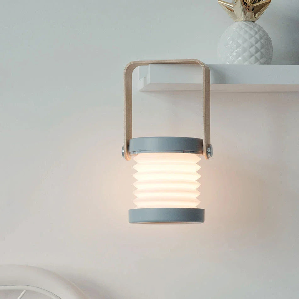 Elegant foldable LED lamp with touch-controlled dimming, rechargeable battery, and modern design for home decor