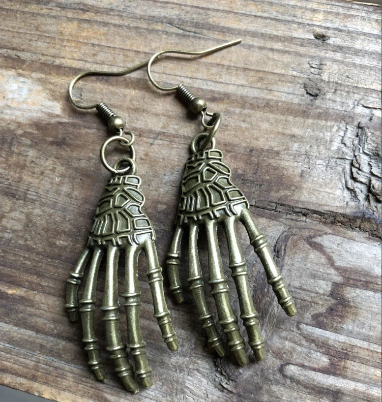 Elegant vintage carved skull and skeleton hands earrings in gold, bronze, and silver finishes