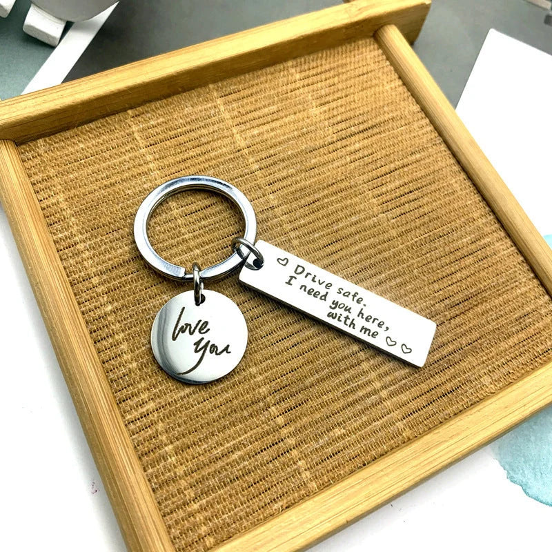 Unisex stainless steel safe driving keychain with elegant lettering