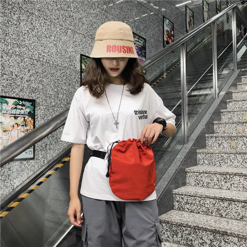 Stylish nylon drawstring waist bag with diagonal design, adjustable fit, and practical storage compartments
