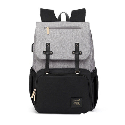 Versatile mummy bag with stroller hooks, side pockets, and zippered compartments for storing baby essentials