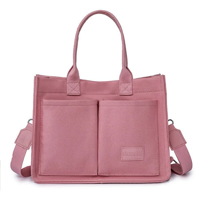 Stylish and durable canvas tote bag with multiple pockets for everyday use