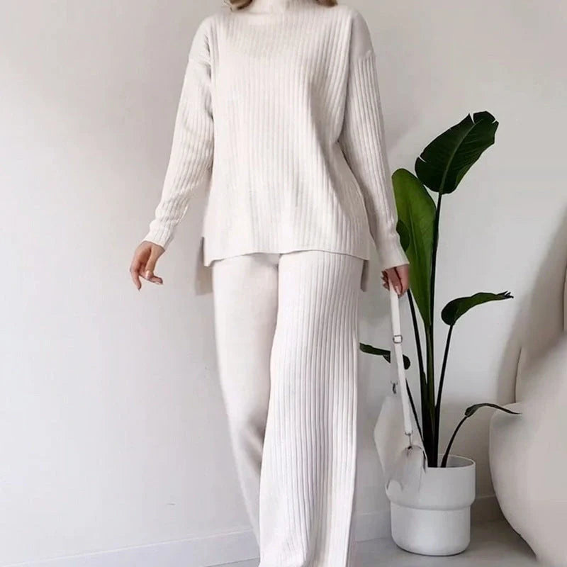 Women's turtleneck knitted suit set in white, black, or green with loose fit and straight trousers