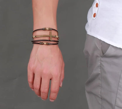 Rugged leather cross bracelet with durable construction and adjustable fit, a versatile accessory for the modern British gentleman