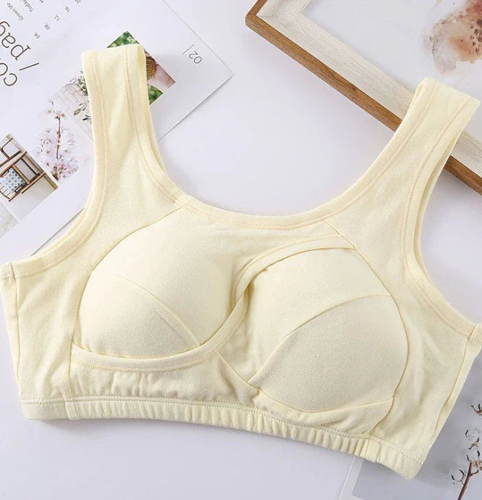 Supportive cotton sports bra with crossover design for lift and support, preventing sagging and bra lines