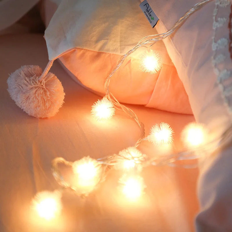 Battery-operated LED curtain garland with plastic stars and fur balls for festive decoration