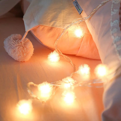 Battery-operated LED curtain garland with plastic stars and fur balls for festive decoration