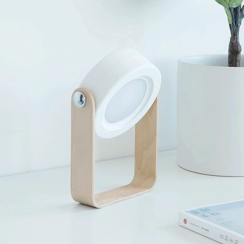 Elegant foldable LED lamp with touch-controlled dimming, rechargeable battery, and modern design for home decor