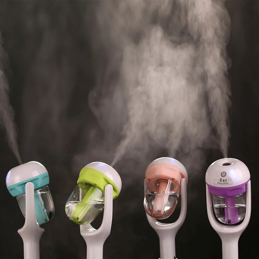 Mini 12V car steam humidifier with aroma diffuser and air purifier in blue, green, pink, and purple