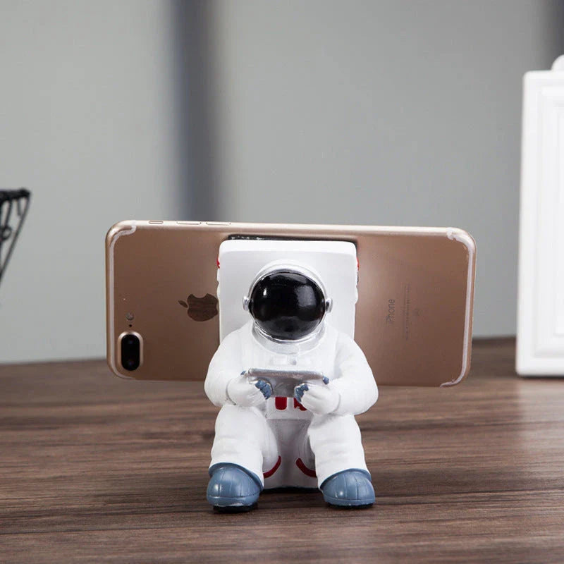 Charming astronaut-themed mobile phone stand made of high-quality resin, designed to securely hold your phone on your desk or workspace