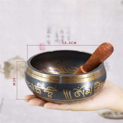 A handcrafted Tibetan singing bowl made of copper, used for meditation and relaxation.