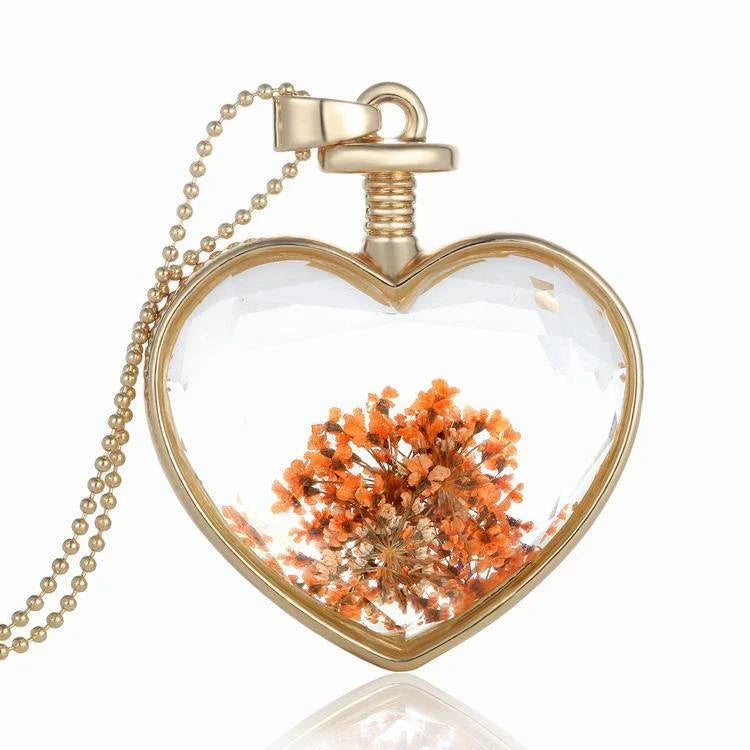 Elegant glass-encased dried flower pendant necklace with bead chain, showcasing a variety of preserved floral arrangements.
