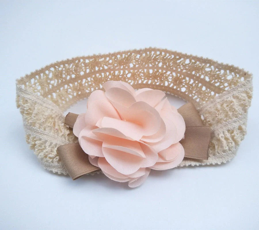 A beautiful floral headband for babies, featuring delicate flowers and a comfortable, adjustable design.