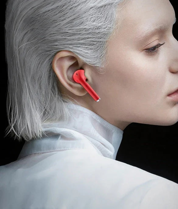 Discreet wireless earbuds in various colors with a charging case, showcasing their sleek and portable design.