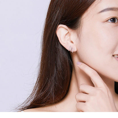 Elegant three-layer sterling silver heart earrings with sparkling gems, perfect for any occasion.