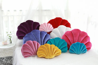 Cosy shell-shaped plush nap pillow in various colours and sizes for ultimate comfort