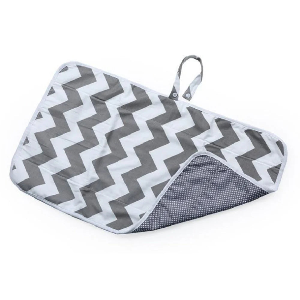 Portable diaper changing pad clutch with built-in toy ring, foldable design for easy transport