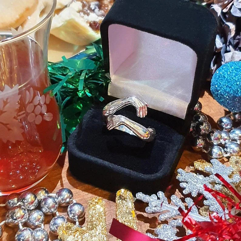 Elegant Adjustable Love Hands Embracing Ring in gold and silver, a perfect symbol of affection