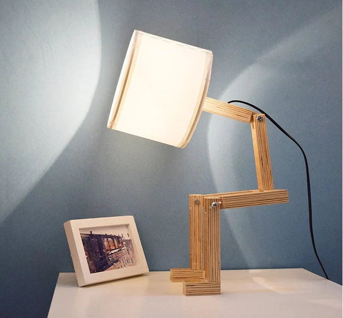 Humanoid table lamp with wooden base and white fabric shade, modern home decor