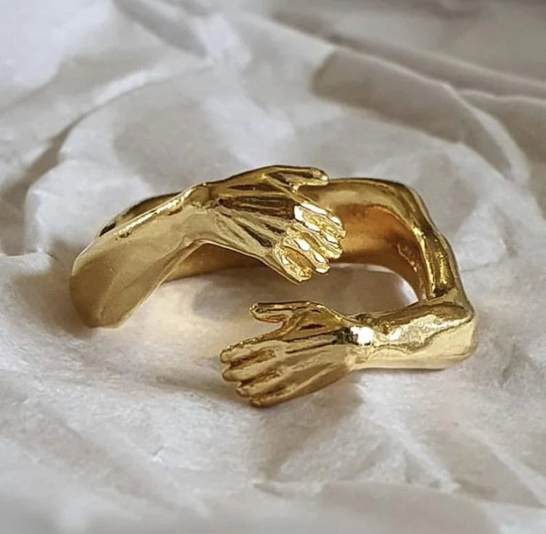Elegant Adjustable Love Hands Embracing Ring in gold and silver, a perfect symbol of affection