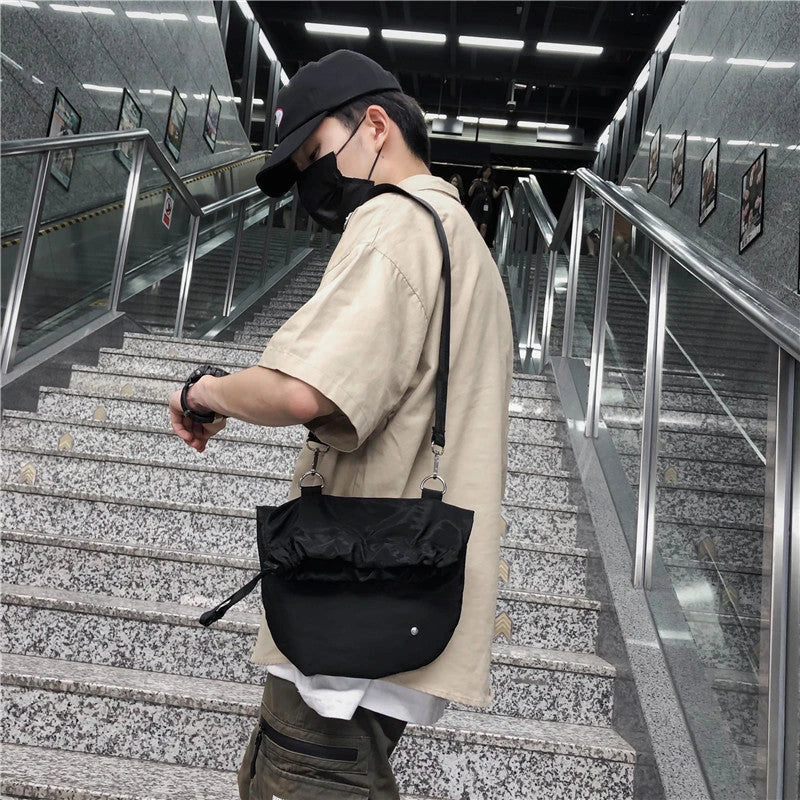 Stylish nylon drawstring waist bag with diagonal design, adjustable fit, and practical storage compartments