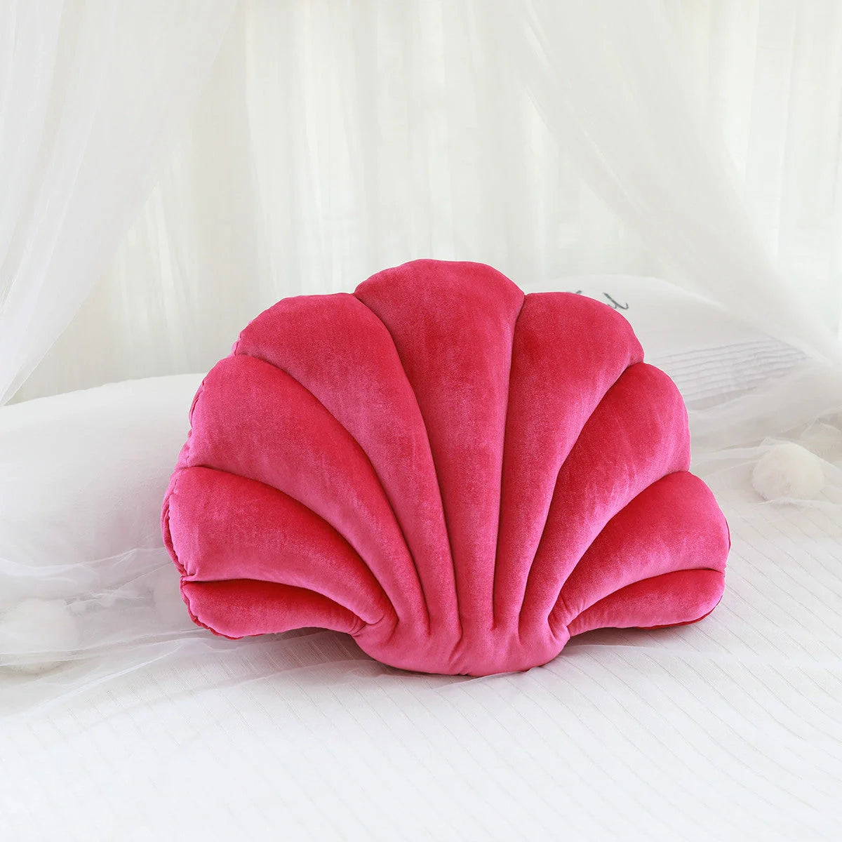 Cosy shell-shaped plush nap pillow in various colours and sizes for ultimate comfort