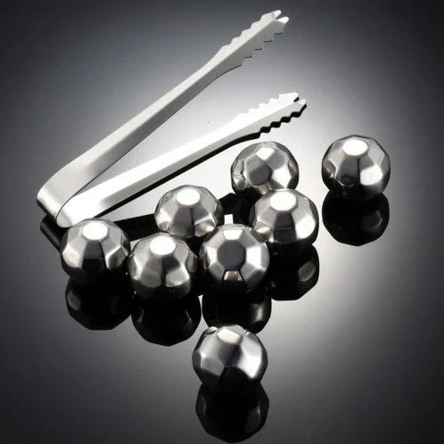 Premium stainless steel whisky chilling stones set in various shapes and sizes, including square, circular, heart, and diamond-shaped stones