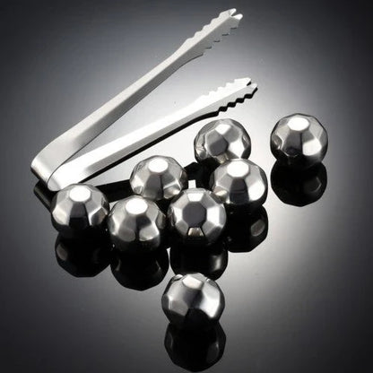Premium stainless steel whisky chilling stones set in various shapes and sizes, including square, circular, heart, and diamond-shaped stones