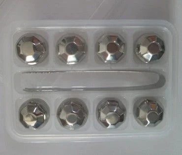 Premium stainless steel whisky chilling stones set in various shapes and sizes, including square, circular, heart, and diamond-shaped stones
