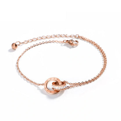 Rose gold titanium steel bracelet with zircon inlay and roman numeral detailing