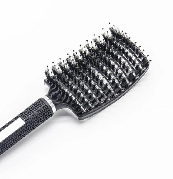 A premium hair brush with a sleek design, featuring soft bristles and a rounded massage function for healthy, detangled hair