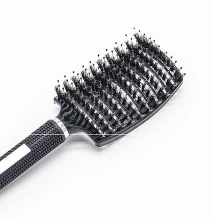 A premium hair brush with a sleek design, featuring soft bristles and a rounded massage function for healthy, detangled hair