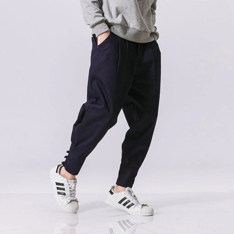 Men's cotton blend casual trousers with button placket in black, blue, and grey