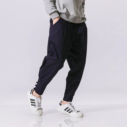 Men's cotton blend casual trousers with button placket in black, blue, and grey