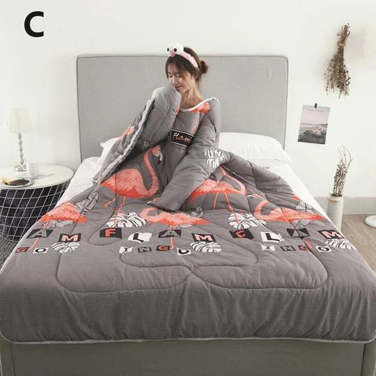 Cozy quilted lounger with sleeves in various colors and sizes, perfect for year-round indoor comfort and relaxation.
