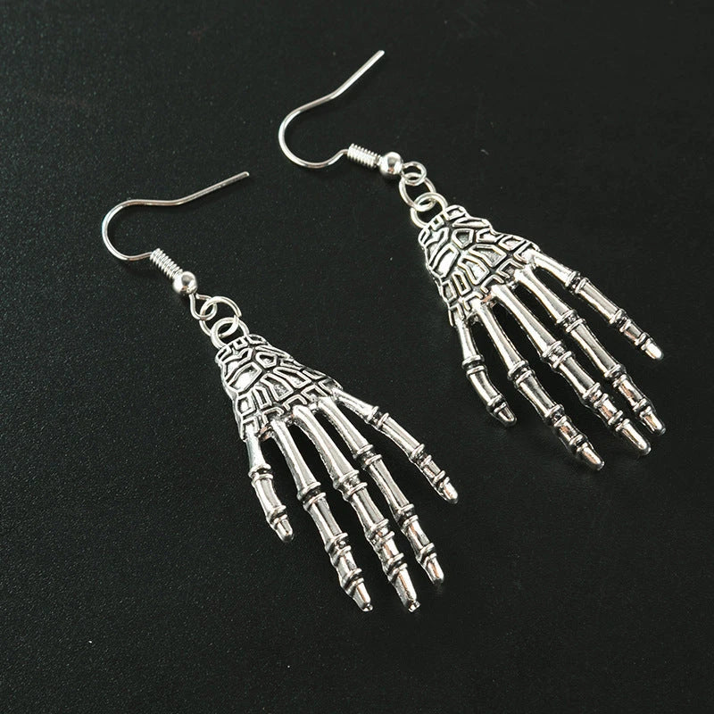 Elegant vintage carved skull and skeleton hands earrings in gold, bronze, and silver finishes
