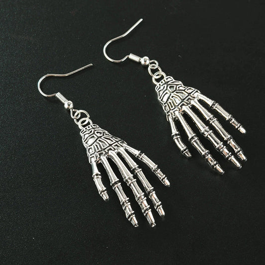 Elegant vintage carved skull and skeleton hands earrings in gold, bronze, and silver finishes