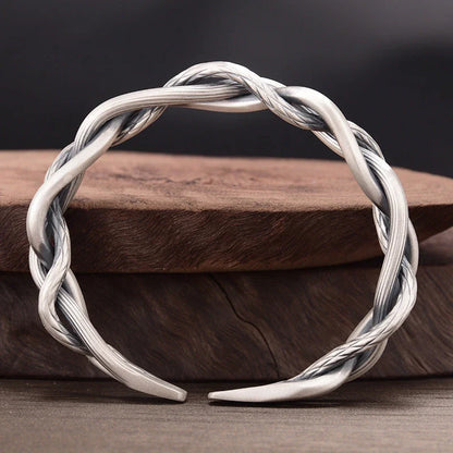 Elegant three-strand sterling silver bracelet with a unique twist design, perfect for couples and everyday wear