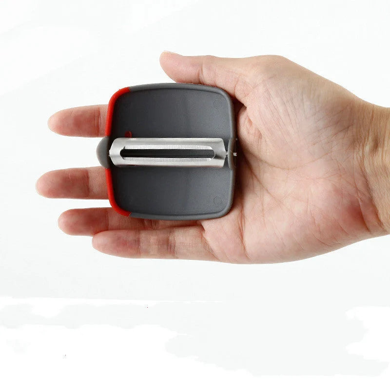 Two-finger peeler with ergonomic grip and stainless steel blade