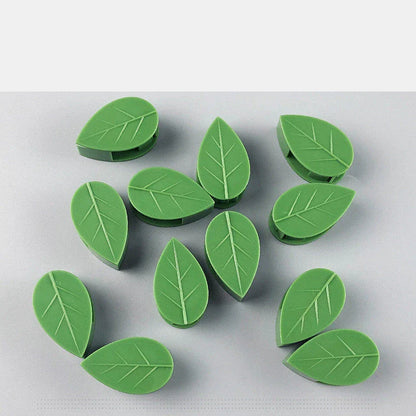 Versatile leaf-shaped plant clips in green, designed to provide discreet and effective support for climbing vines and potted plants